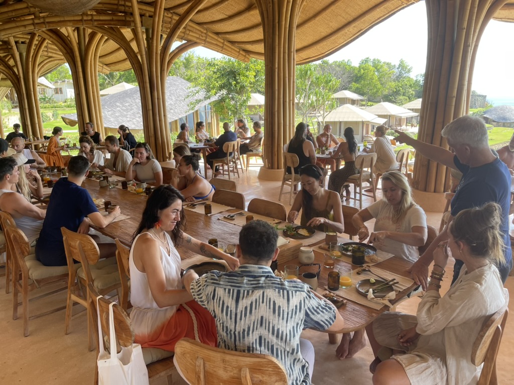 Long communal table under a bamboo cathedral