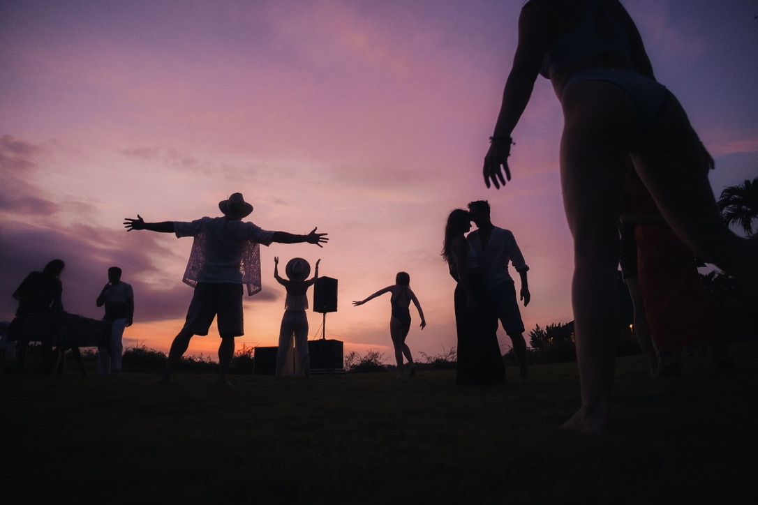 Silhouettes dancing into a violet Bali sunset