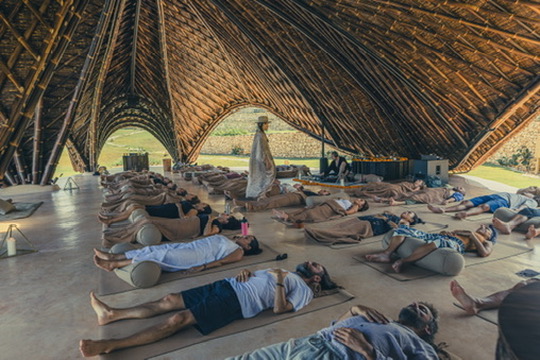 Long bamboo hall full of guests in final rest