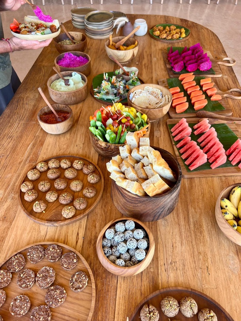 Long wooden table laden with shared feast