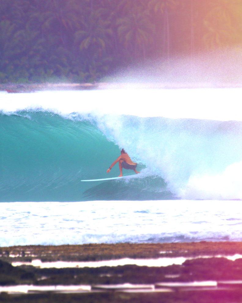 Surfing a clean wave at sunrise