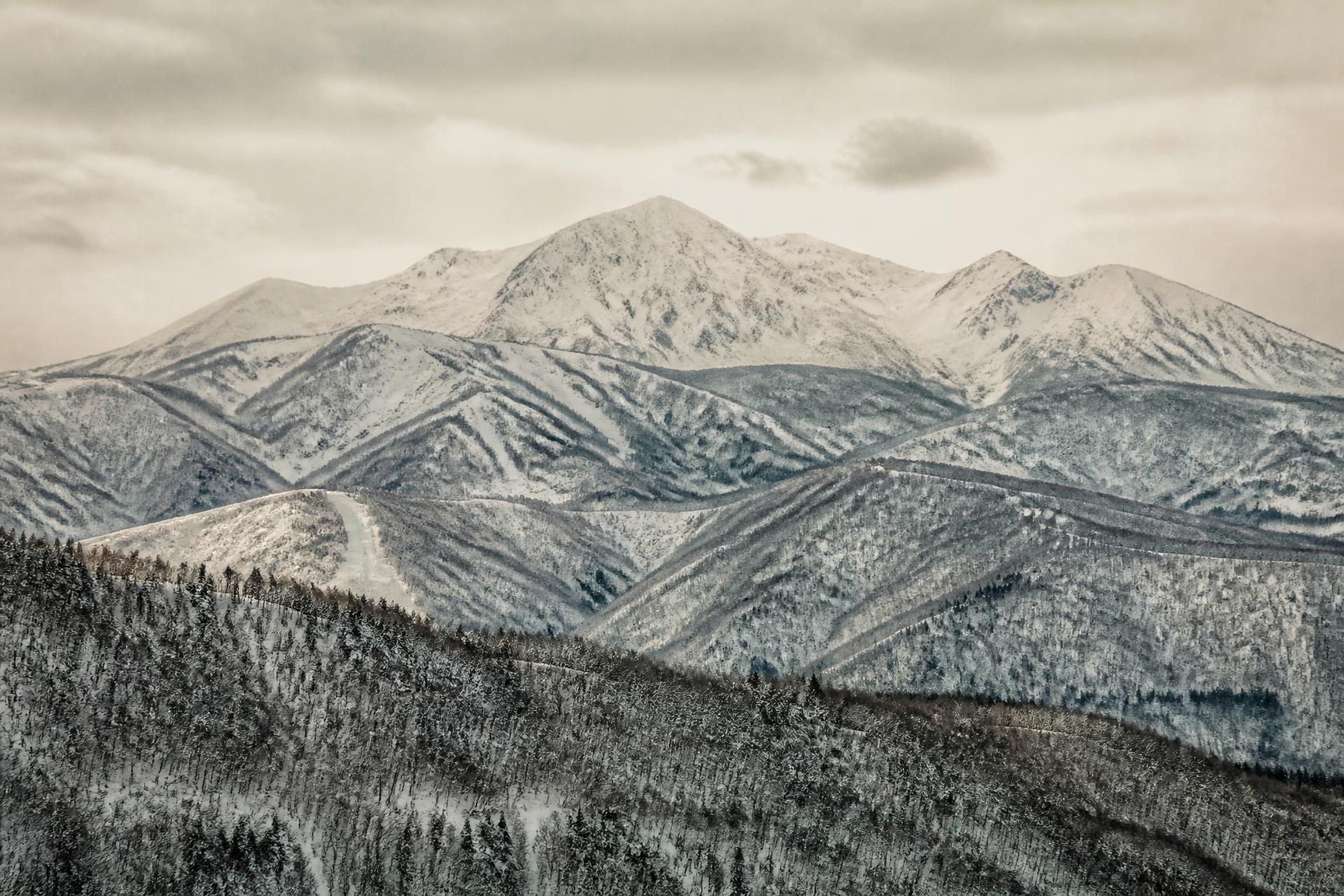 Snow-covered peaks of Myoko, Japan under a soft winter sky